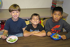 Liam Smith, Jason Platt, and Noah Bonadonna enjoy the harvest